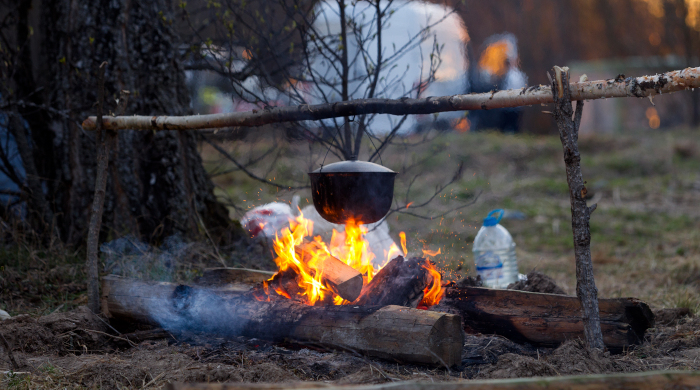 Campfire With A Cooking Pot; rv in background