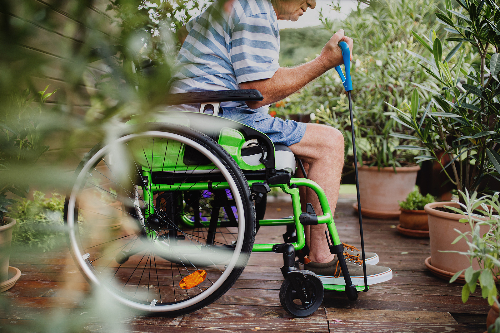 Senior Man In Wheelchair Doing Exercise On Terrace stay fit despite limited mobility