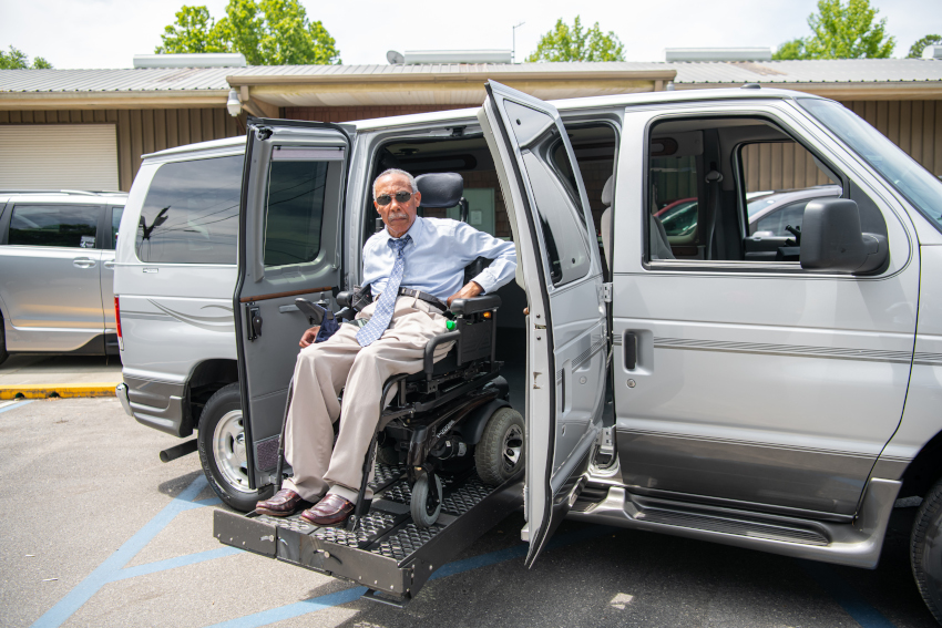 RV & Custom Lifts Example: An elderly gentleman uses a lift to exit with his powerchair from a large van