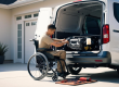 wheelchair van owner in a wheelchair works on vehicle maintenance in the back of the accessible van