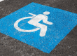 a wheelchair accessible parking spot's emblem painted on concrete