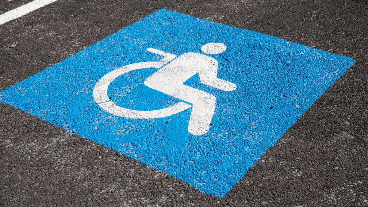 a wheelchair accessible parking spot's emblem painted on concrete
